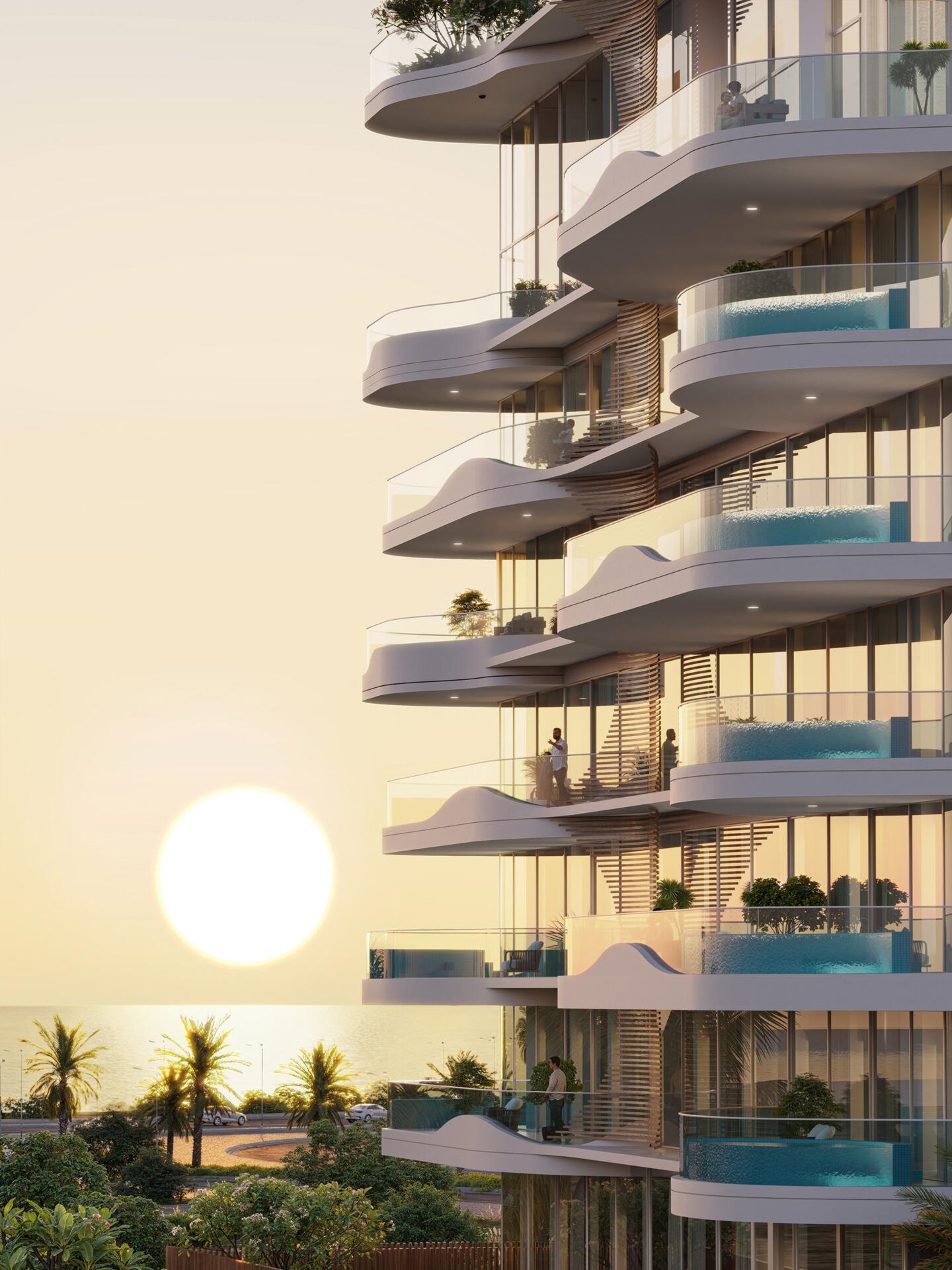 La Perla curved facade at sunset with private pools